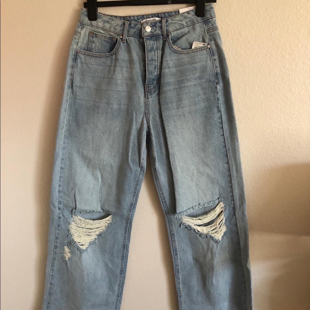 High rise wide leg jeans. Never worn. Brand new. Holes in the knee area.